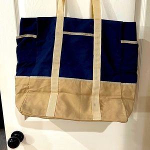 Canvas tote with pockets galore.  Acrylic interior and nylon handles.